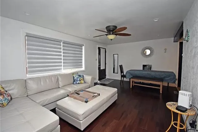 a living room with furniture a window and a table