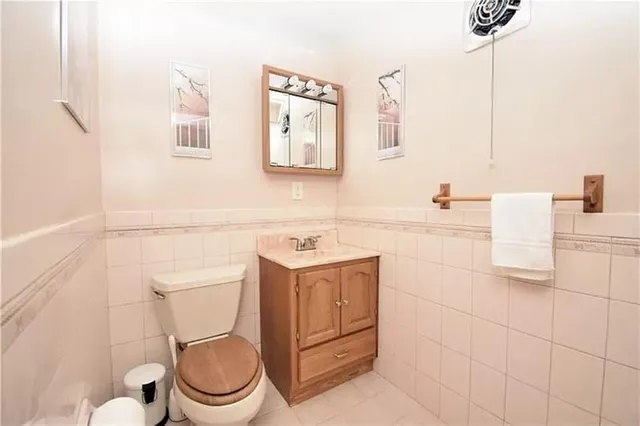 a bathroom with a sink toilet and mirror