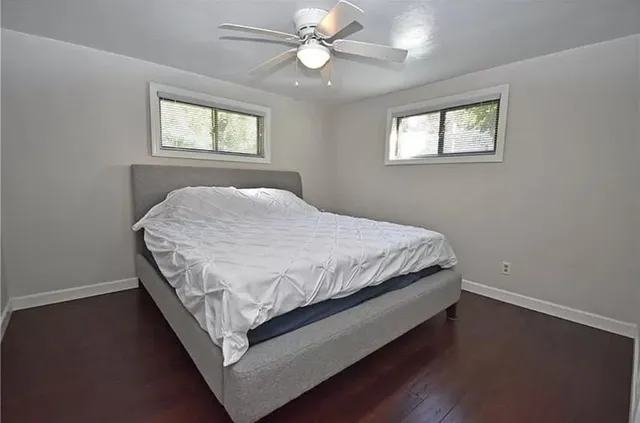 a bed sitting in a bedroom next to a window