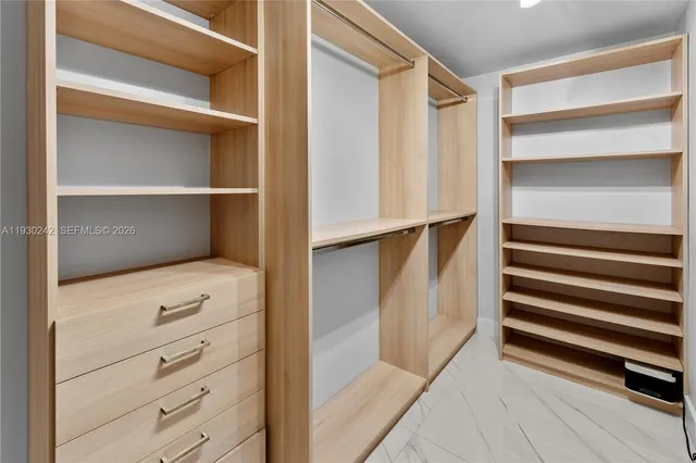 a view of a closet area with an empty room