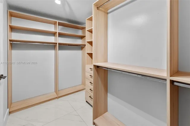 a bathroom with a shower sink mirror and toilet