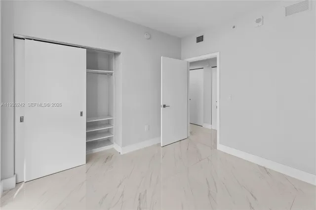 a view of an empty room with a bathroom