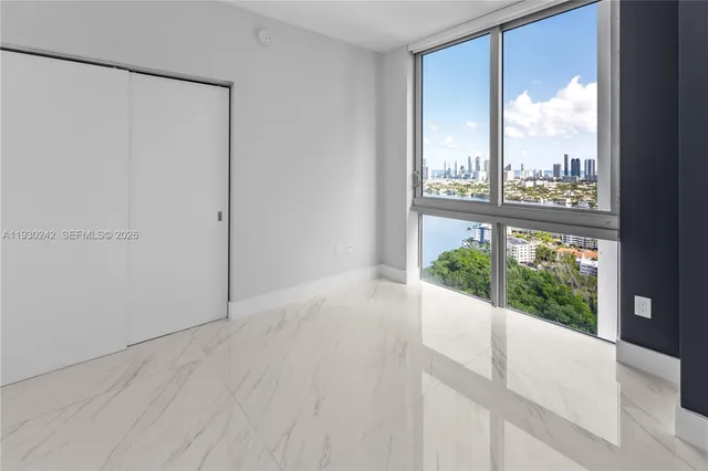 front view of a house with a yard and potted plants