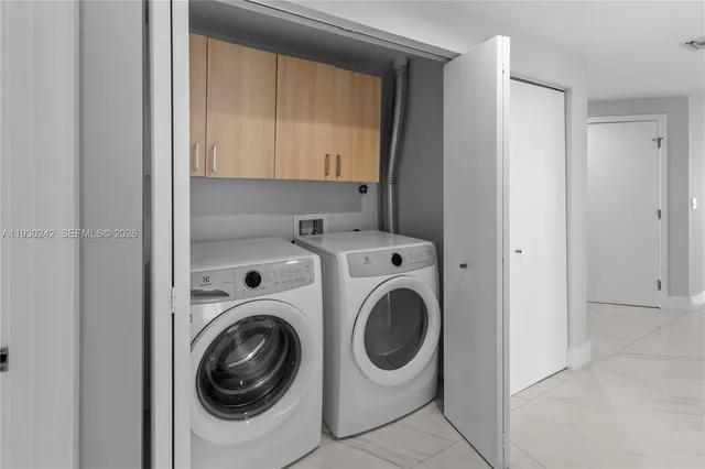 a view of swimming pool with table and chairs water fall and palm tree
