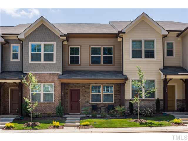 690 Wickham Ridge Road, Unit 141 Apex, NC 27539 - Photo 1 of 25 a front view of a house with garden