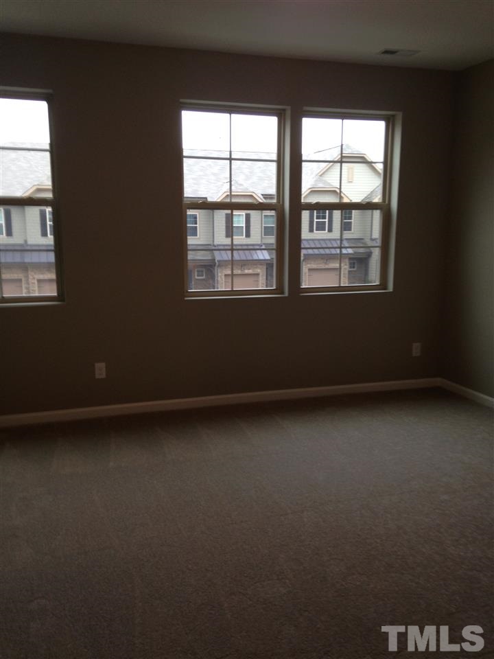 690 Wickham Ridge Road, Unit 141 Apex, NC 27539 - Photo 13 of 25 a view of an empty room with a window