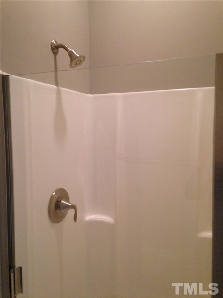 690 Wickham Ridge Road, Unit 141 Apex, NC 27539 - Photo 16 of 25 a close view of a shower in the bathroom