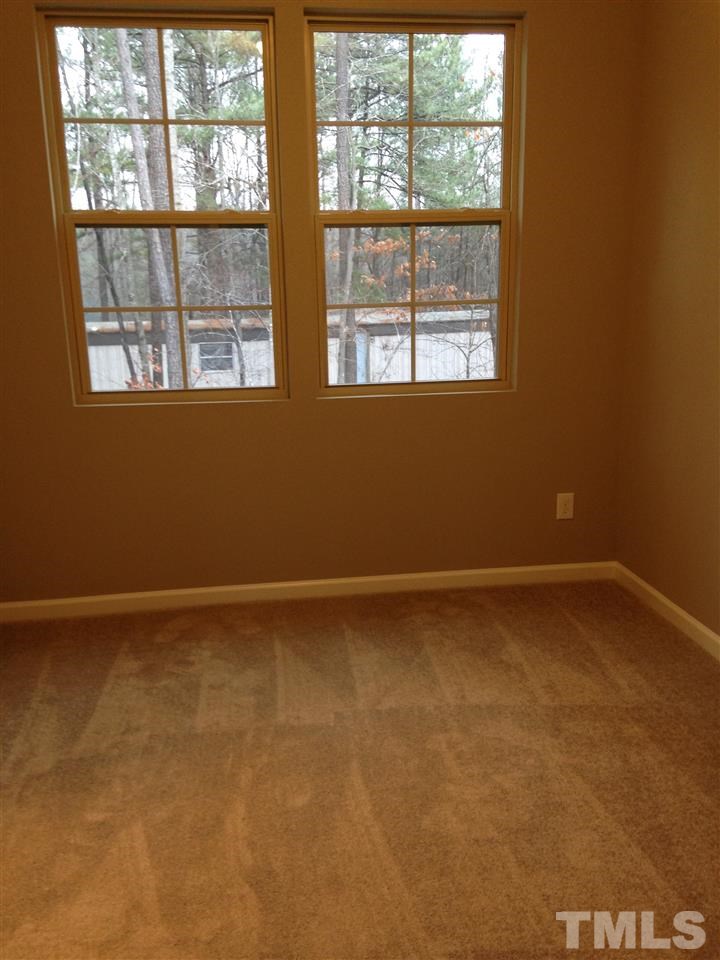690 Wickham Ridge Road, Unit 141 Apex, NC 27539 - Photo 19 of 25 an empty room with a window