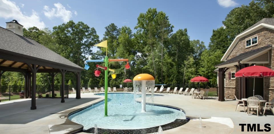 690 Wickham Ridge Road, Unit 141 Apex, NC 27539 - Photo 23 of 25 a swimming pool with outdoor seating and outdoor seating
