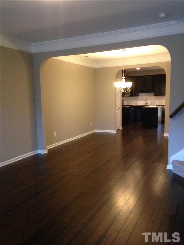 690 Wickham Ridge Road, Unit 141 Apex, NC 27539 - Photo 4 of 25 a view of a living room with wooden floor
