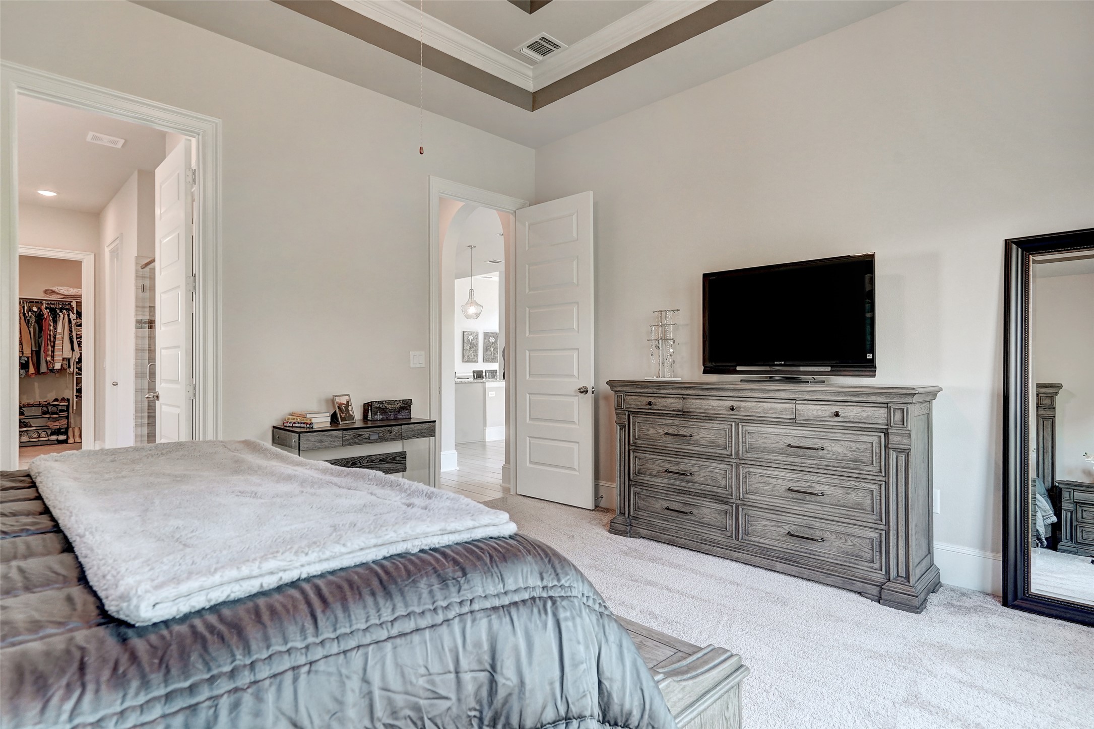 720 Rawson Bend Austin, TX 78738 - Photo 16 of 40 Bedroom featuring a spacious closet, light carpet, and ornamental molding