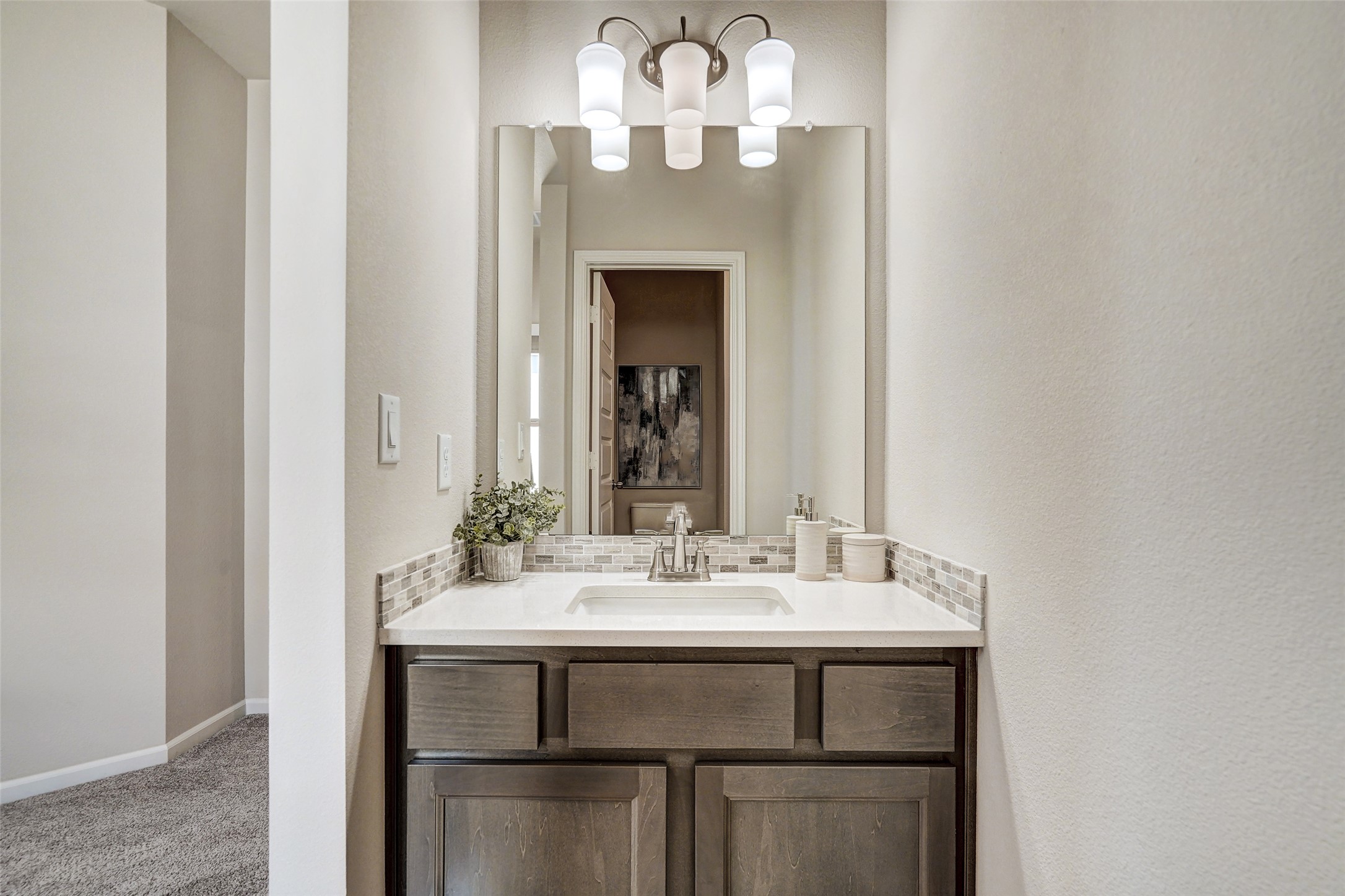 720 Rawson Bend Austin, TX 78738 - Photo 25 of 39 Bathroom featuring vanity, light carpet, tasteful backsplash, and a chandelier