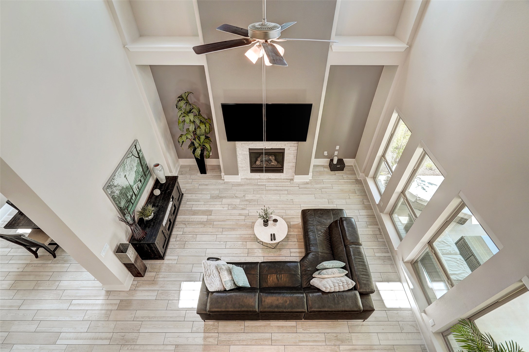 720 Rawson Bend Austin, TX 78738 - Photo 33 of 39 Living area with a high ceiling, a fireplace, and ceiling fan
