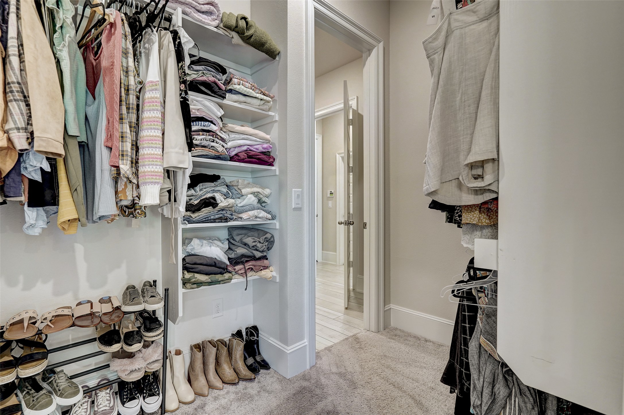 720 Rawson Bend Austin, TX 78738 - Photo 34 of 39 a view of walk in closet with clothes and shoes