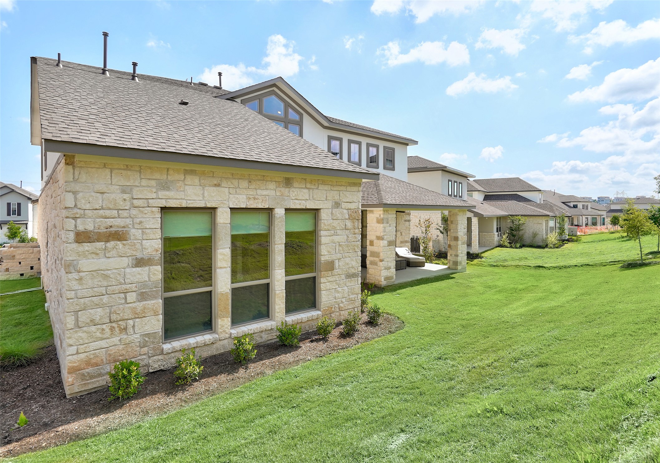720 Rawson Bend Austin, TX 78738 - Photo 38 of 39 a front view of a house with a garden and yard