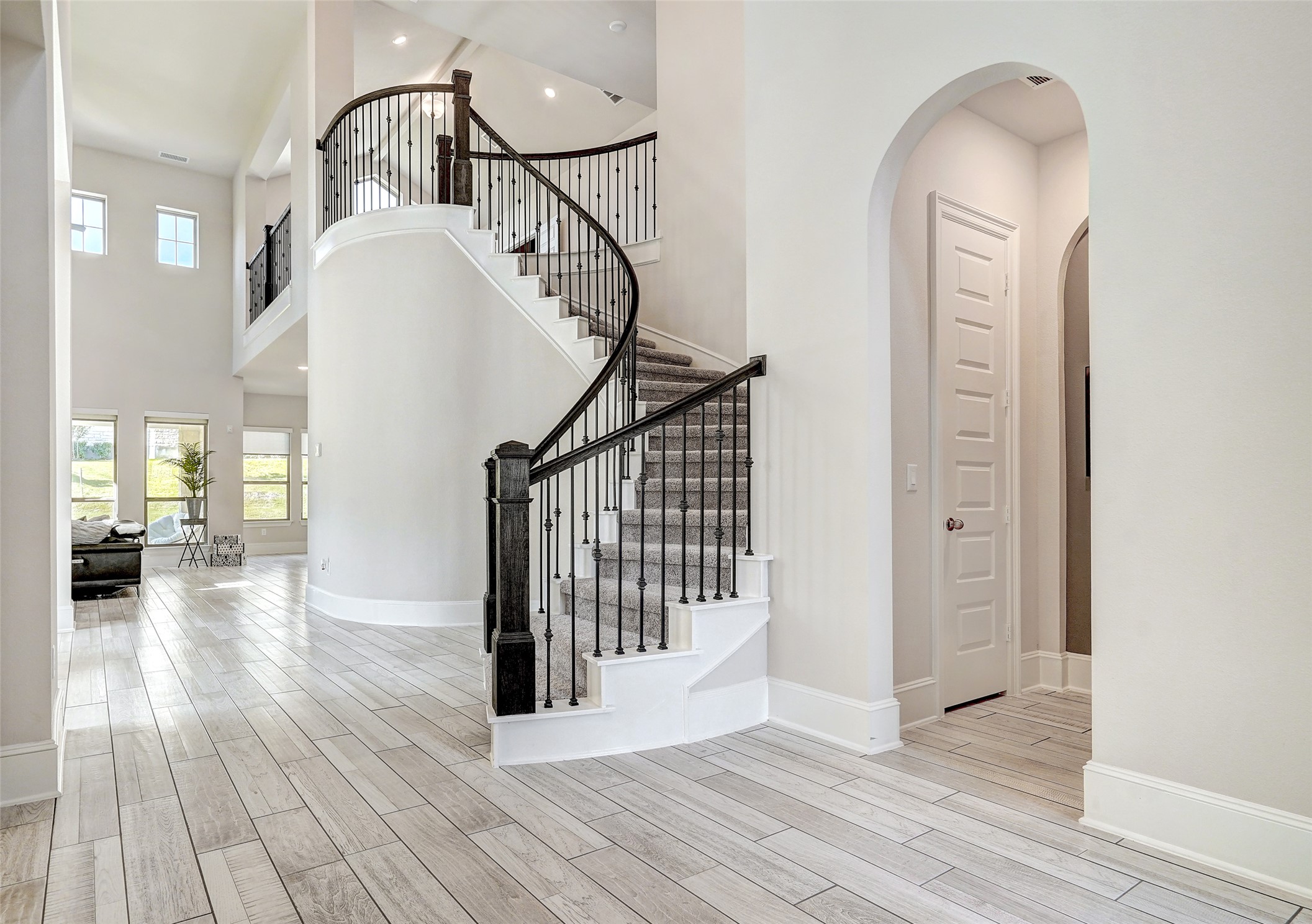 720 Rawson Bend Austin, TX 78738 - Photo 6 of 40 Stairs with wood finish floors, arched walkways, and a high ceiling