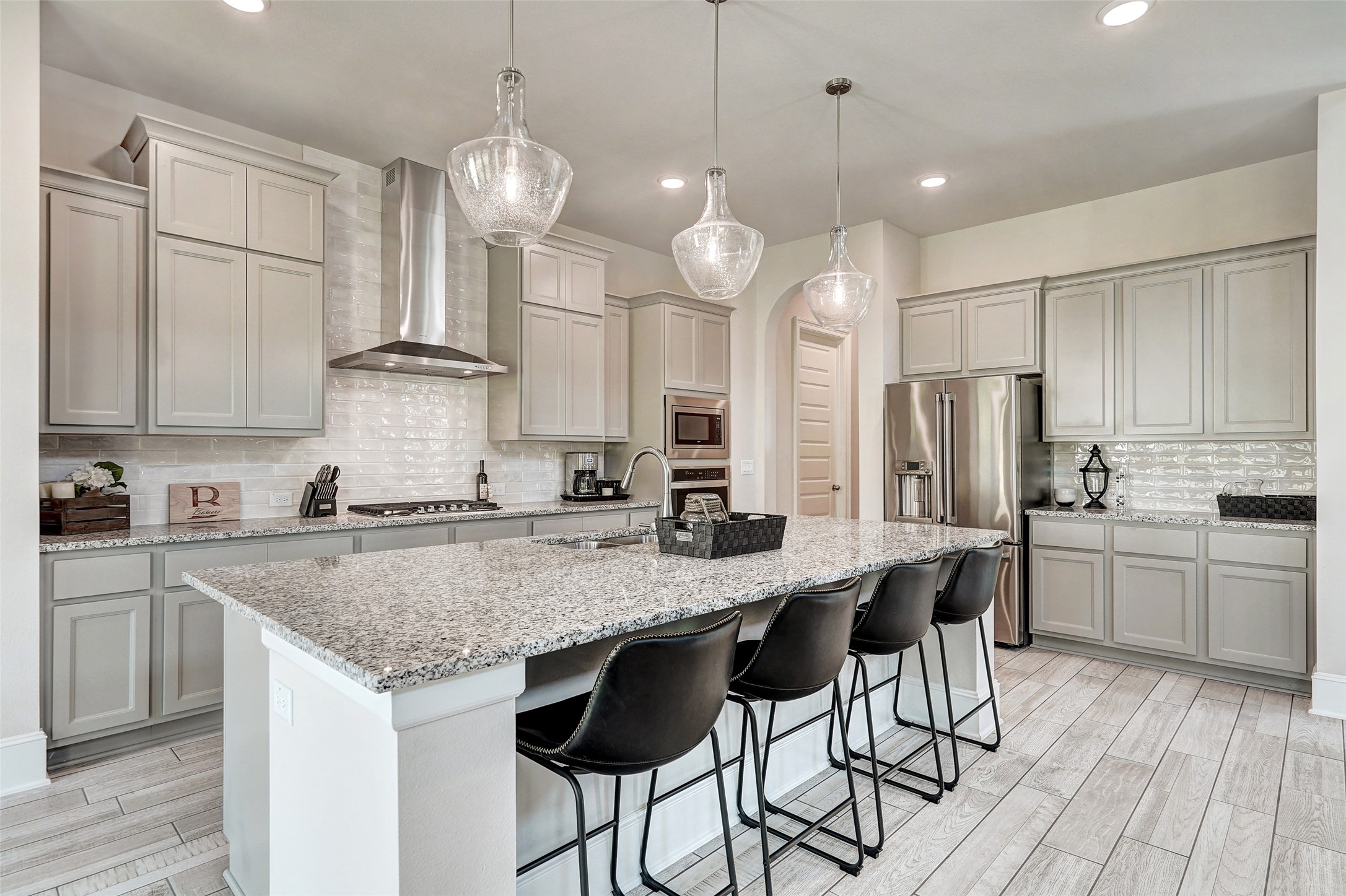720 Rawson Bend Austin, TX 78738 - Photo 9 of 39 a kitchen with stainless steel appliances granite countertop a sink a stove a oven a counter space and cabinets