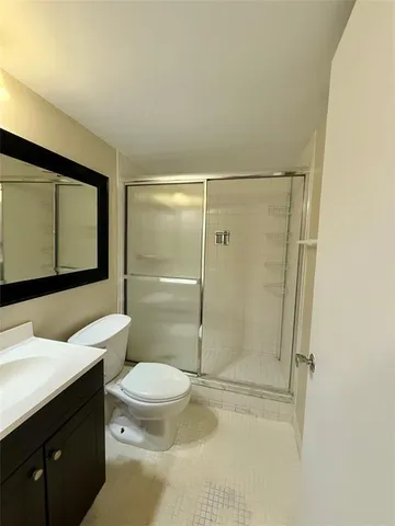 a bathroom with a toilet a sink and shower