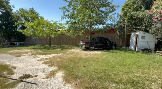 a car parked in front of yellow house