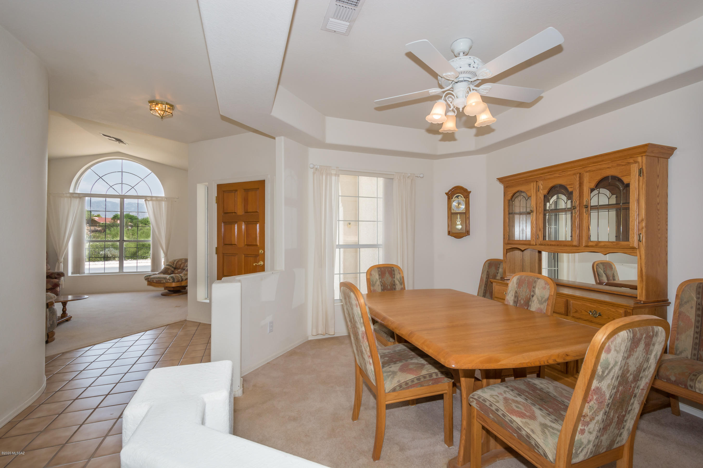 11341 Silver Pheasant Loop Oro Valley, AZ 85737 - Photo 7 of 41 a dining room with furniture a chandelier and wooden floor
