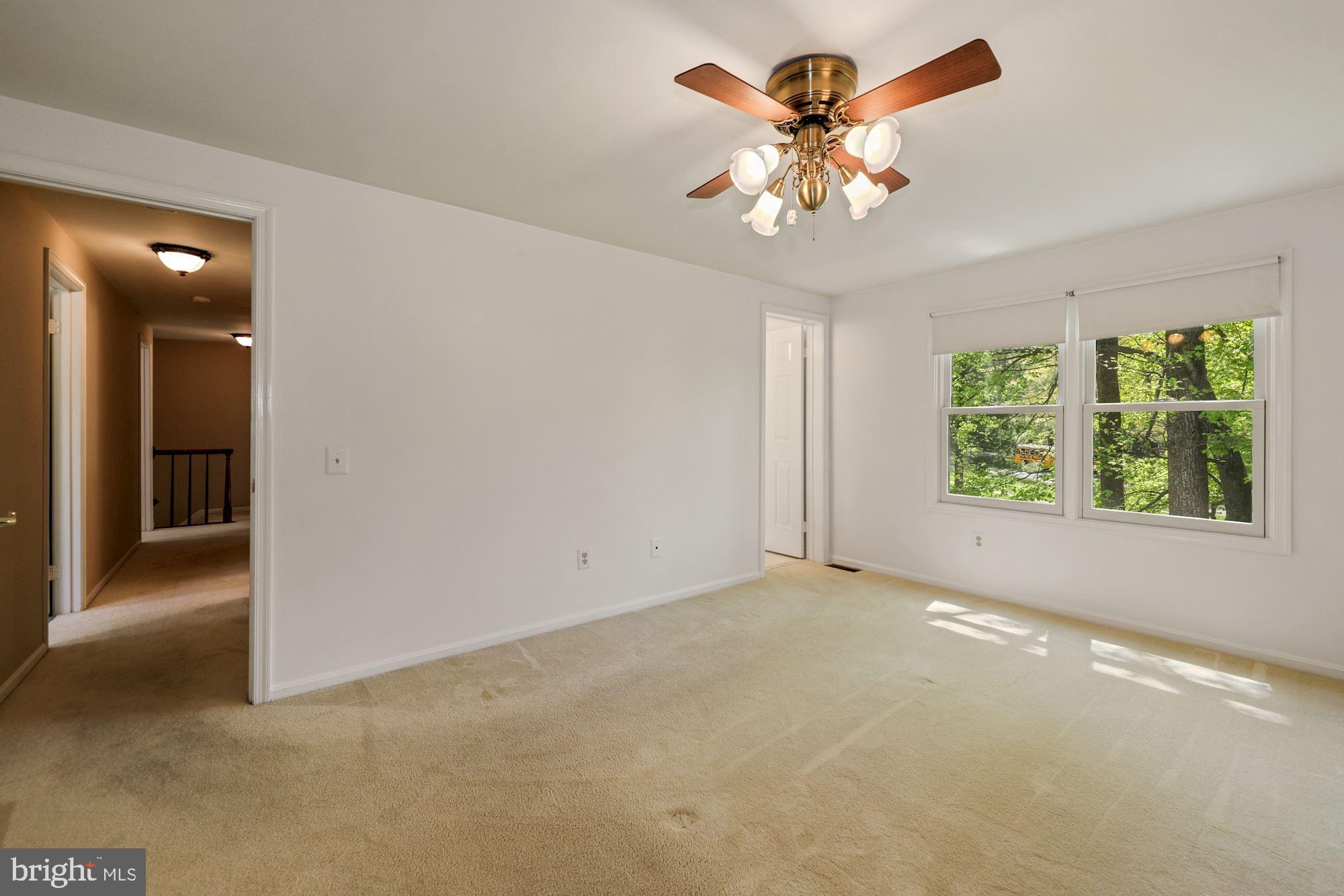 11321 Classical Lane Silver Spring, MD 20901 - Photo 21 of 35 an empty room with windows and chandelier fan