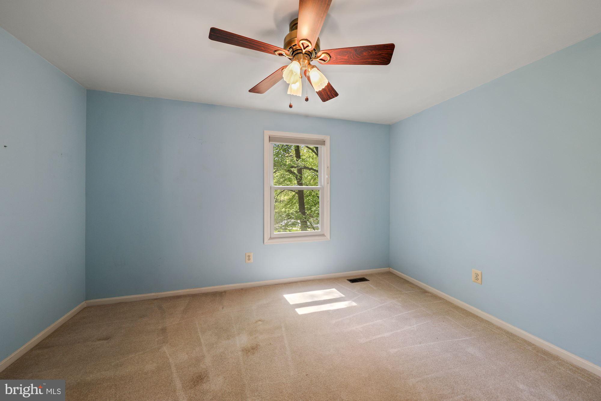 11321 Classical Lane Silver Spring, MD 20901 - Photo 26 of 35 an empty room with windows and chandelier fan
