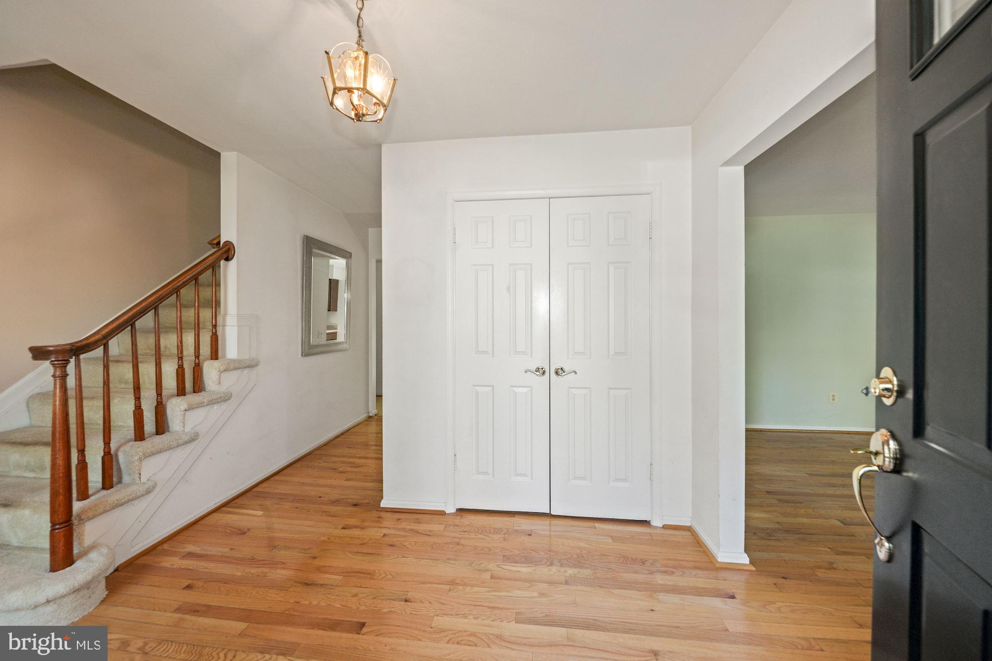 11321 Classical Lane Silver Spring, MD 20901 - Photo 4 of 35 a view of a hallway with wooden floor and staircase