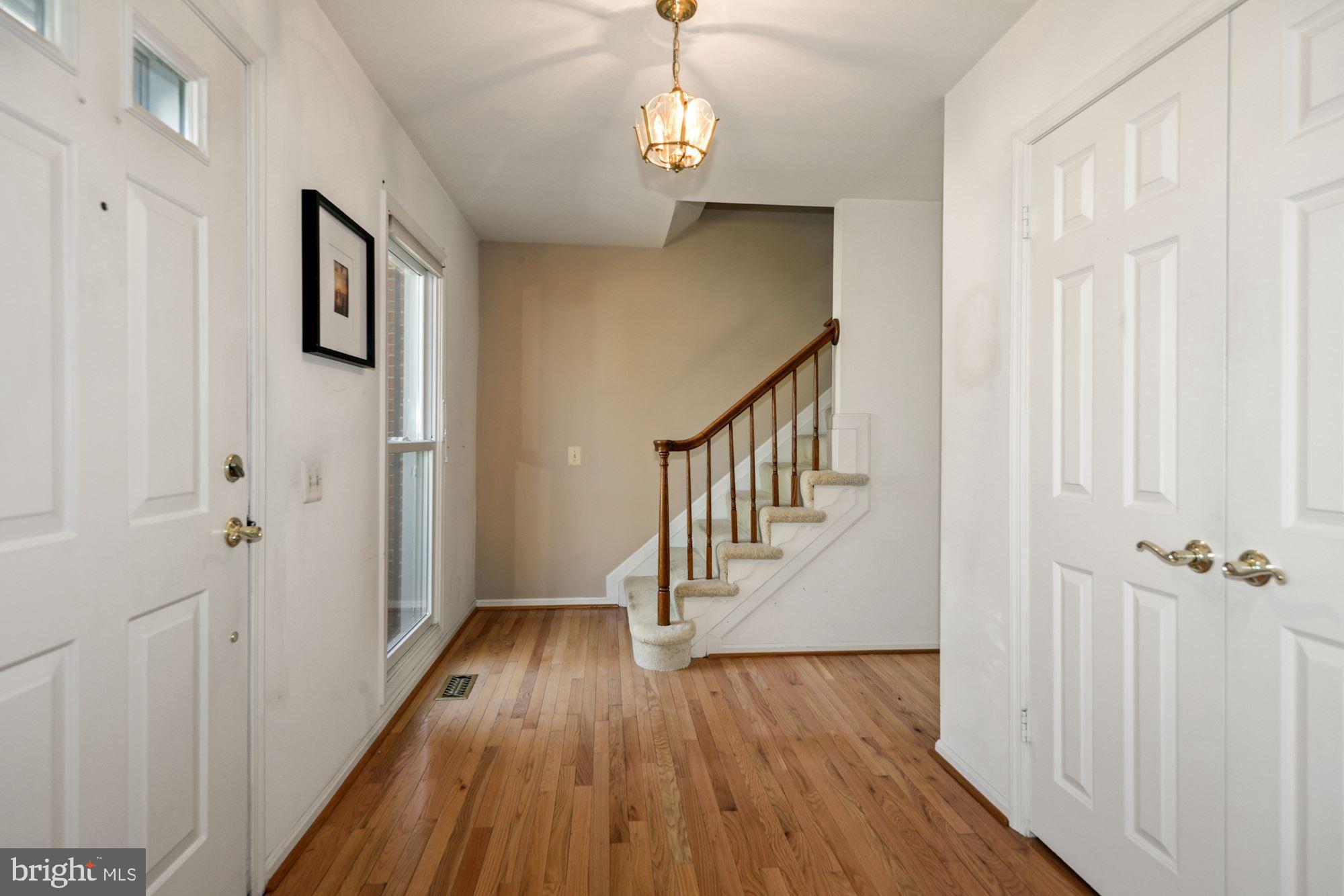 11321 Classical Lane Silver Spring, MD 20901 - Photo 5 of 35 a view of a hallway with wooden floor and staircase