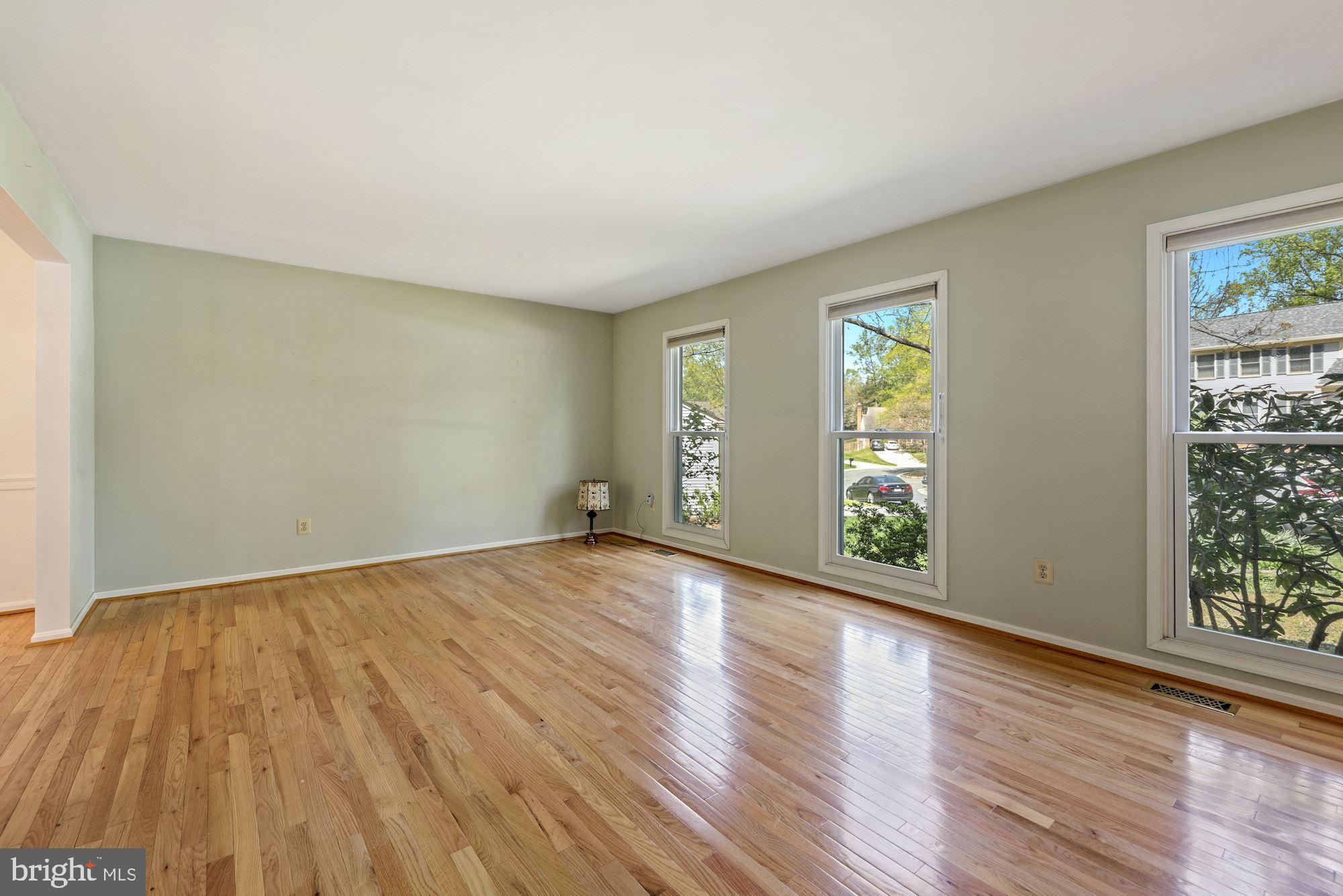 11321 Classical Lane Silver Spring, MD 20901 - Photo 6 of 35 a view of an empty room with wooden floor and a window
