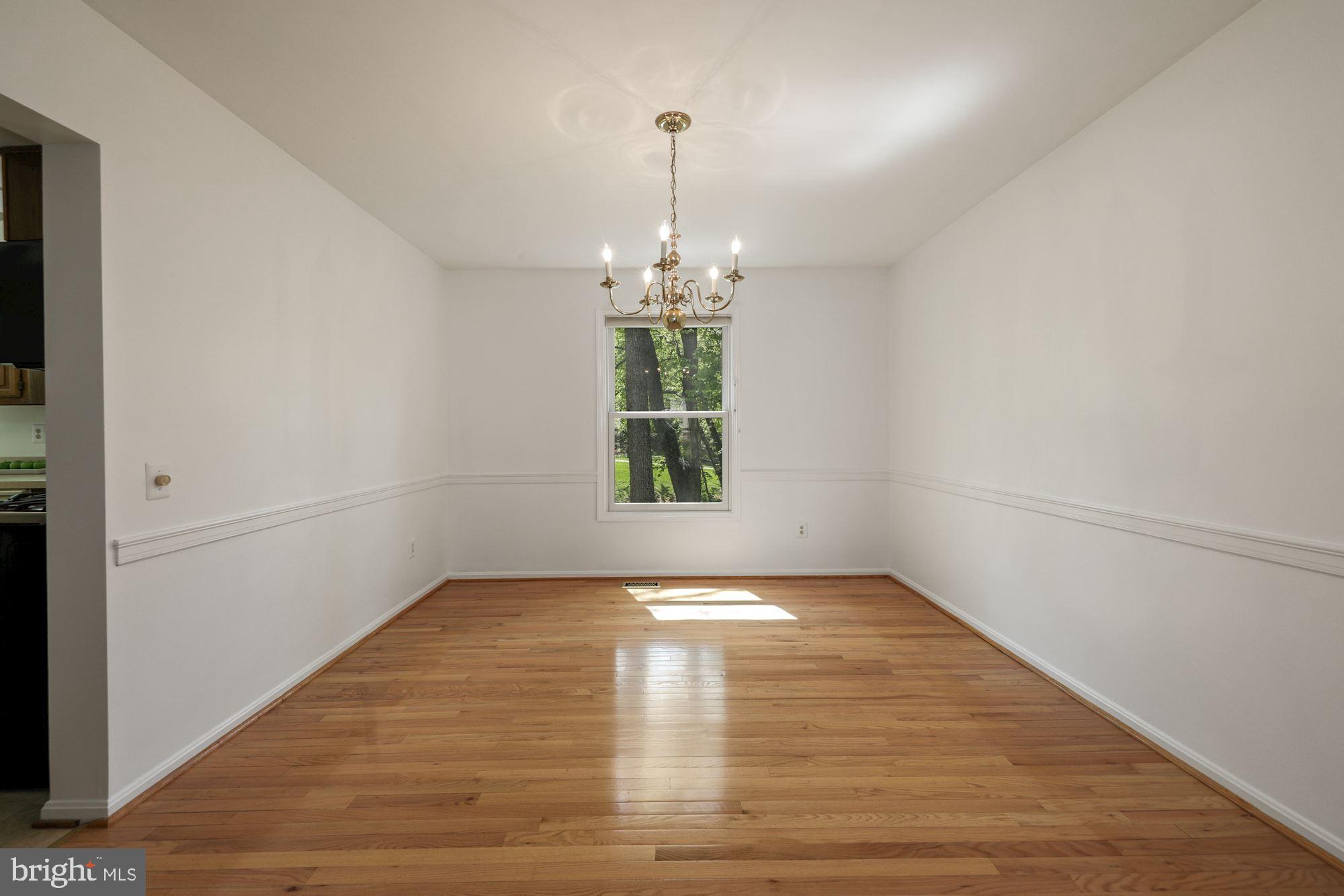 11321 Classical Lane Silver Spring, MD 20901 - Photo 8 of 35 a view of a room with window wooden floor and brick walls