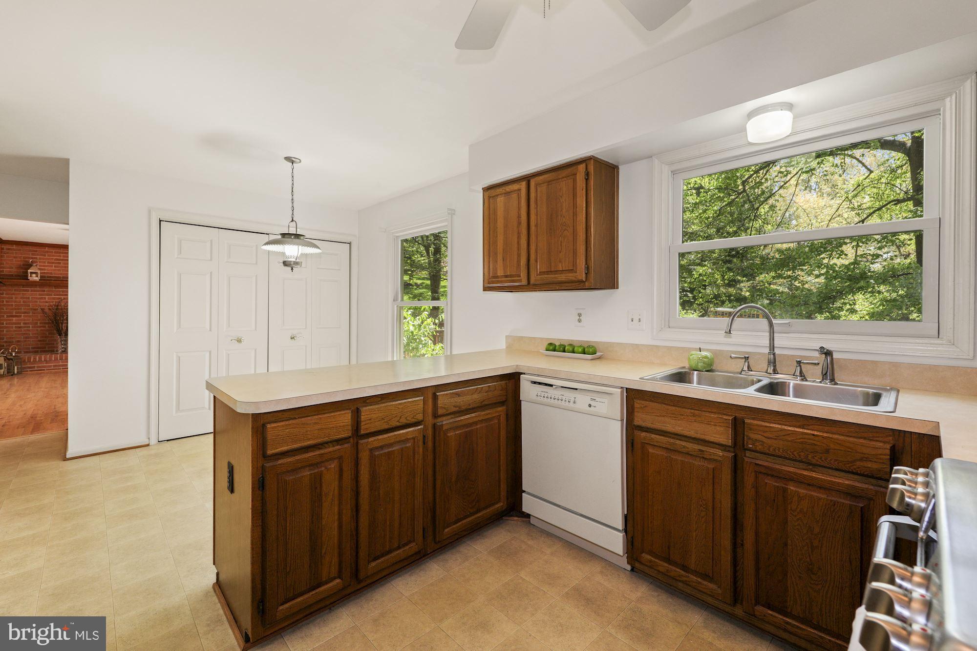 11321 Classical Lane Silver Spring, MD 20901 - Photo 10 of 35 a kitchen with a sink stove and cabinets