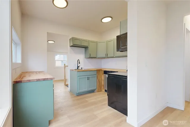 a kitchen with a sink and a stove top oven