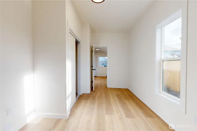 a view of a room with wooden floor and a window