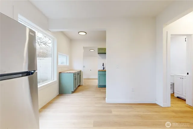 a view of a kitchen with a sink and a refrigerator