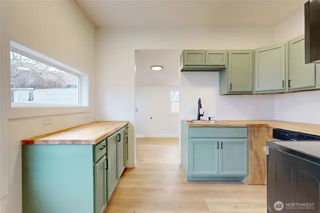 a kitchen with a sink and cabinets