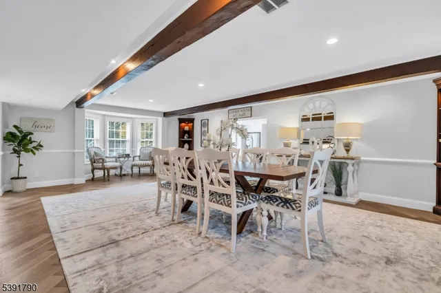 a dining room with furniture and wooden floor