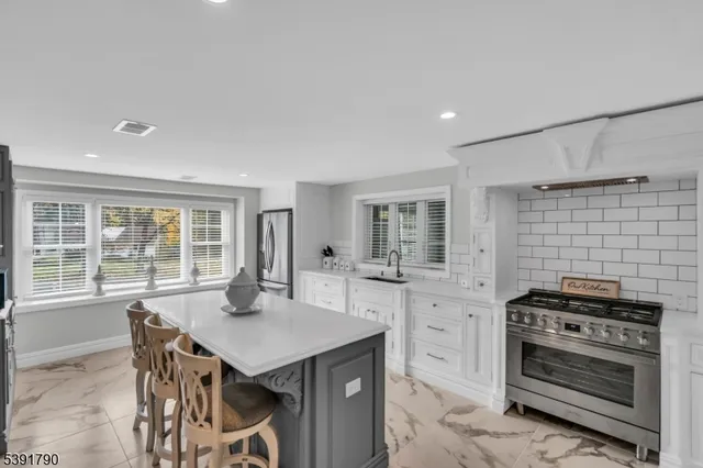 a kitchen with a stove a refrigerator and a table