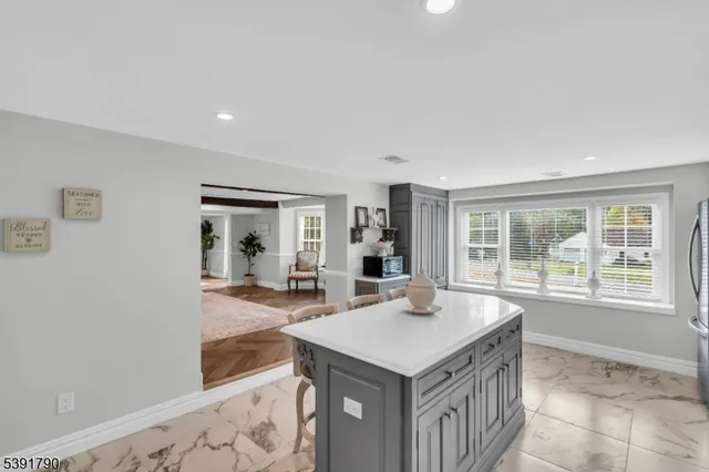 a view of a kitchen with a sink and dishwasher with wooden floor