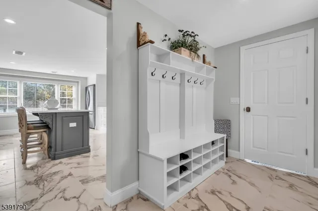 a view of an entryway with wooden floor and windows