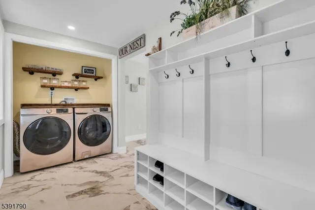 a utility room with sink dryer and washer