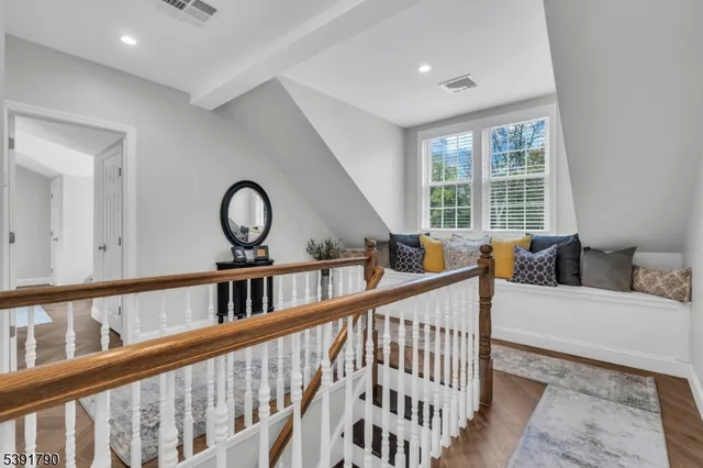 a view of staircase with furniture and window