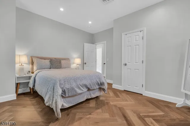 a spacious bedroom with a bed and a shower