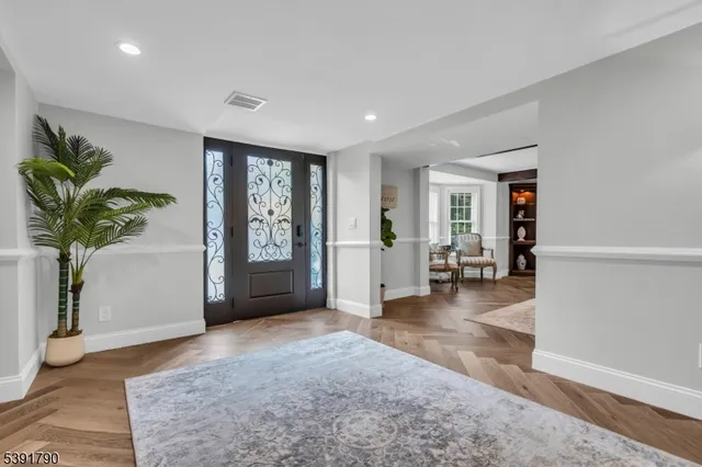 a view of a livingroom with wooden floor and a potted plant