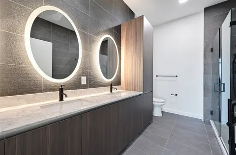 a bathroom with a double vanity sink and a mirror