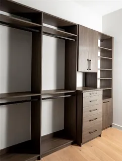 a view of walk in closet with empty racks
