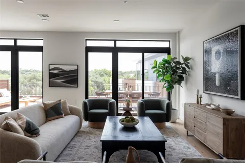 a living room with furniture fireplace and a large window