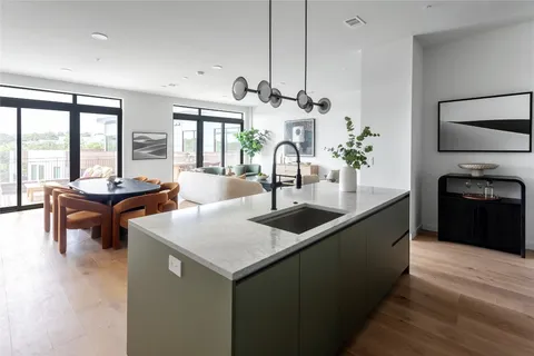 a kitchen with counter top space and living room
