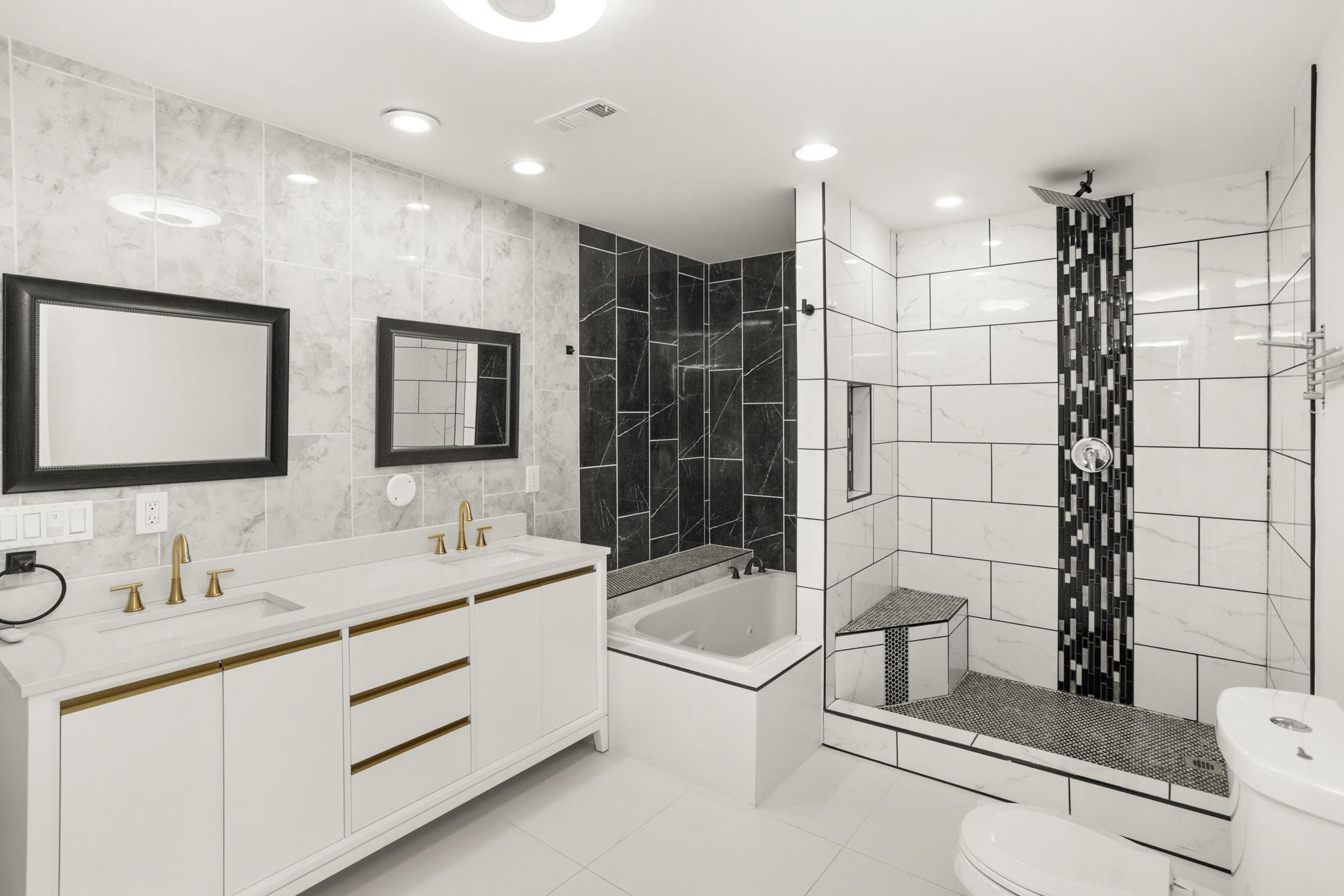 239 East Bledsoe Street Gallatin, TN 37066 - Photo 11 of 52 a bathroom with a double vanity sink toilet and shower