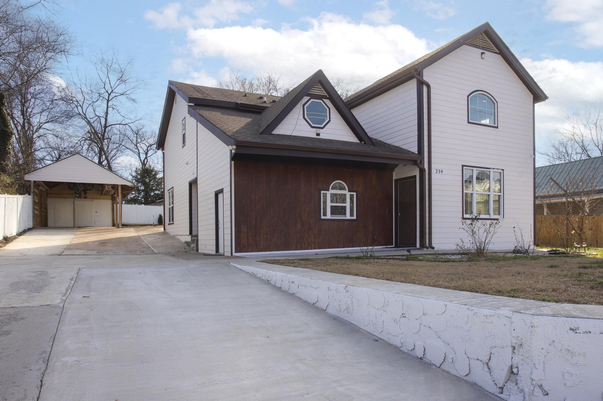 239 East Bledsoe Street Gallatin, TN 37066 - Photo 50 of 52 a front view of a house with a yard and garage