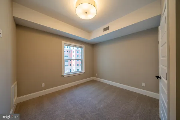 an empty room with windows and entrance